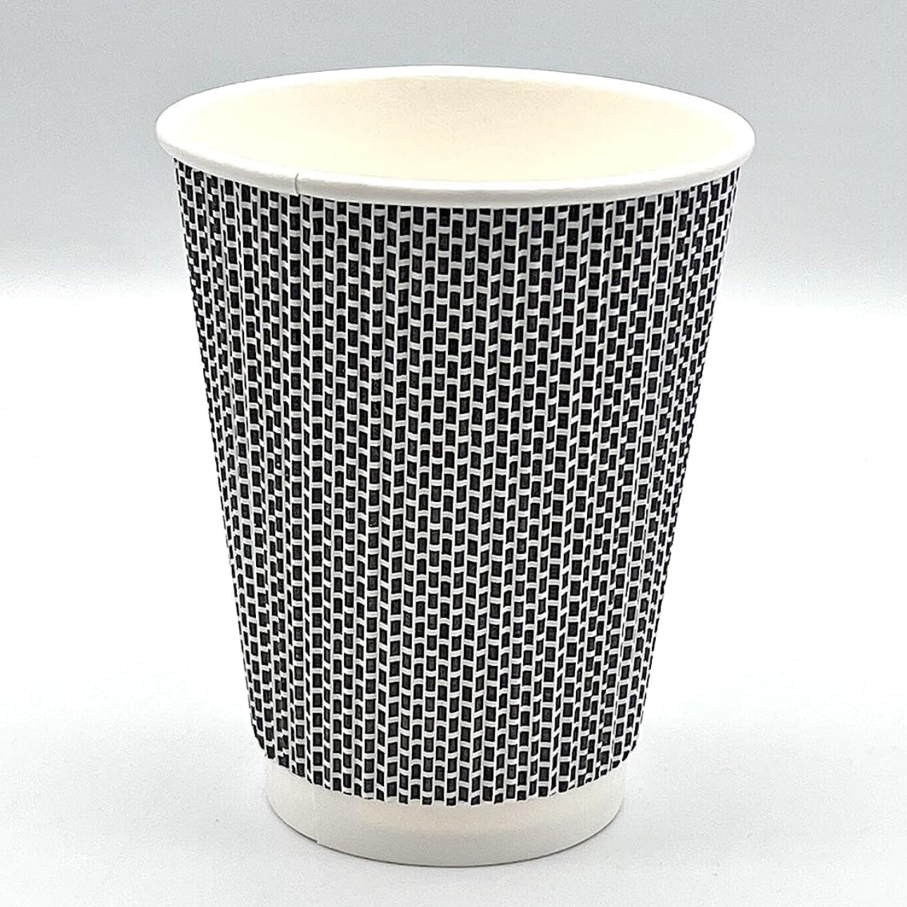 Black and white patterned paper cup on a light gray background