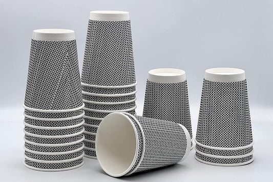 Set of paper cups with black pattern on a gray background