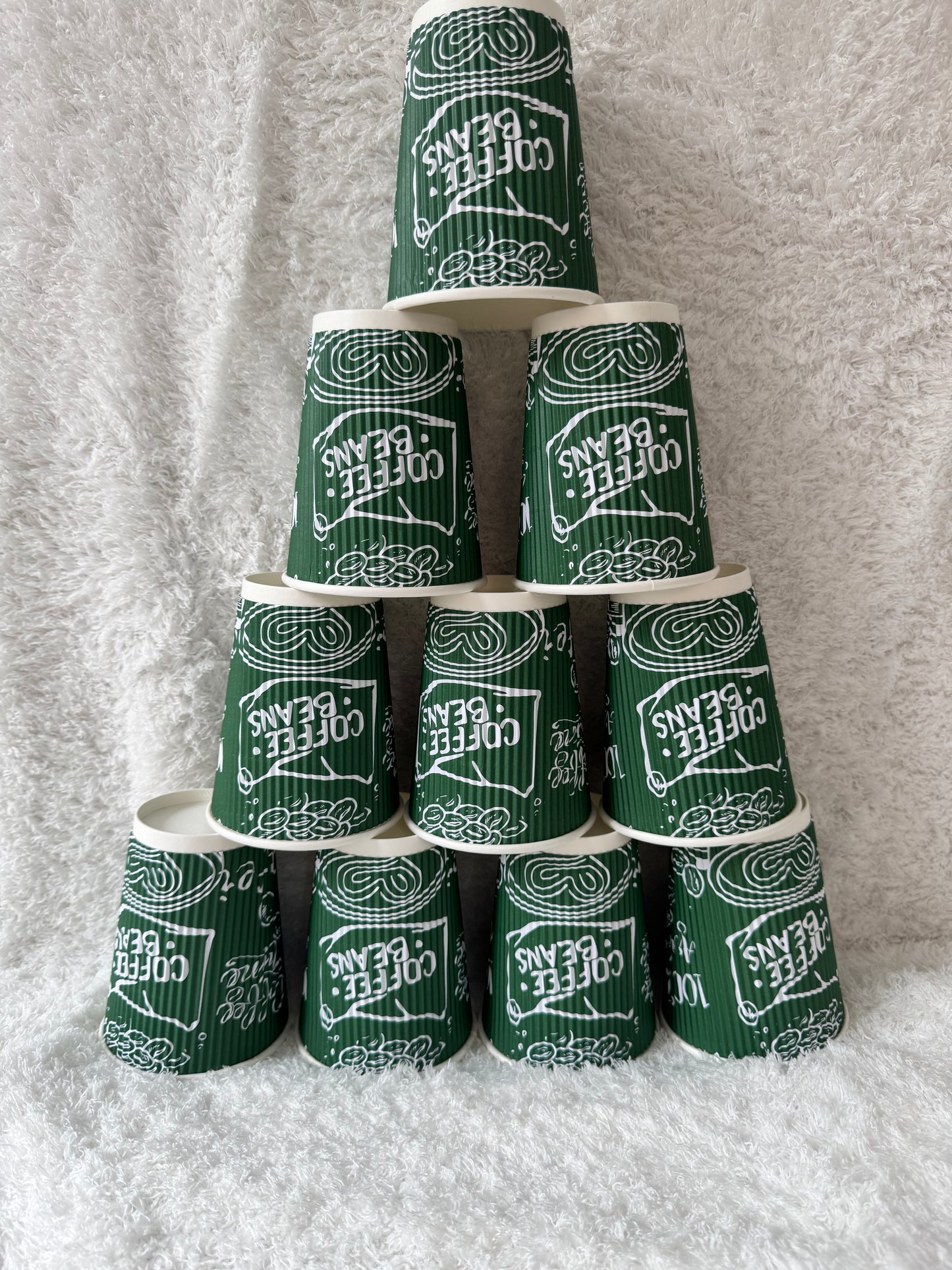 Green and white coffee-themed cracker packages on a gray surface