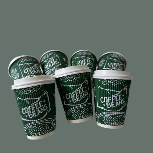 Set of green coffee cups with white lids on a gray background